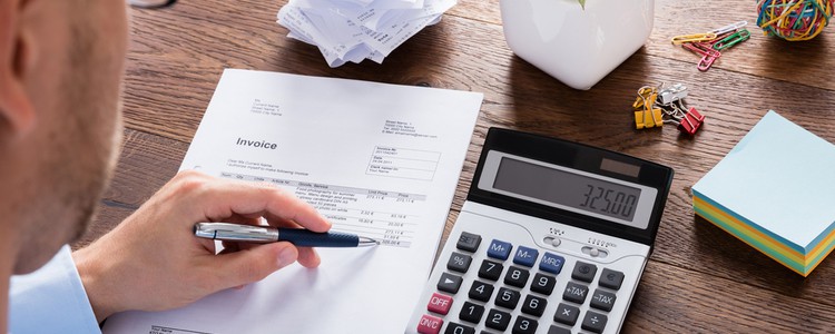 Accountant calculating tax using a calculator