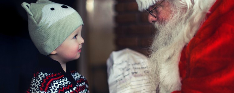 child receiving gift from Santa Claus