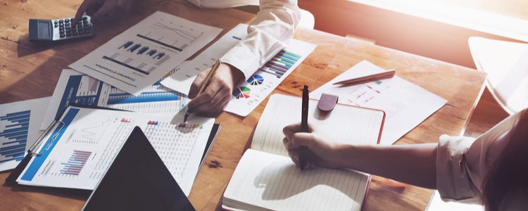 Two people looking at financial information