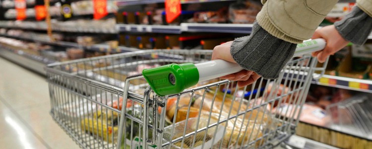 person pushing a trolley around a supermarket