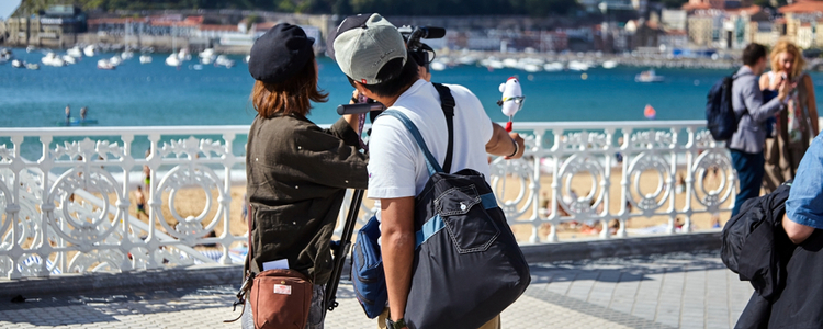 film crew recording on a sea front in Spain