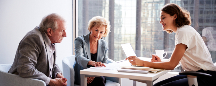 Senior couple talking to financial planner