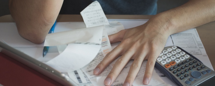 stressed man looking at receipts