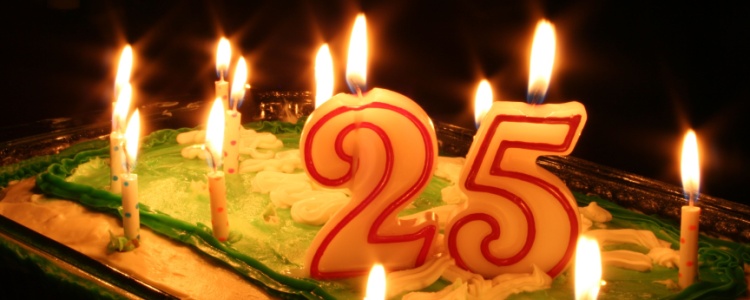 a birthday cake with candles and the number “25”
