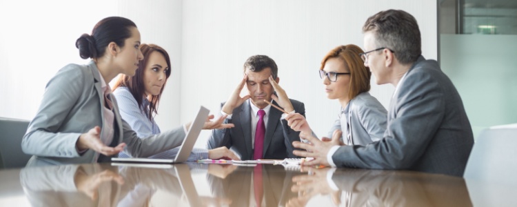 four people arguing in a meeting