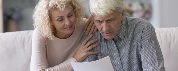 Concerned senior couple looking at paperwork