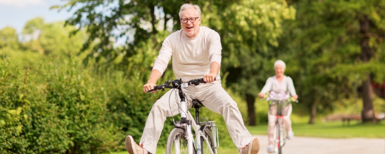 Happy senior man riding a bicycle