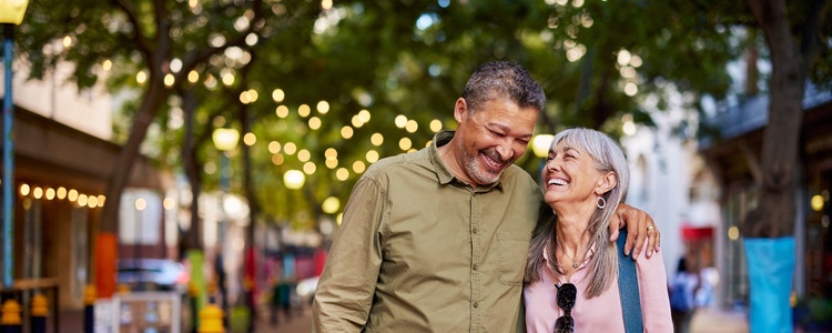 Happy senior couple walking in a city